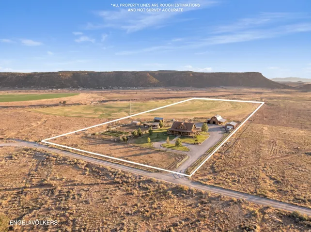 Expansive rural property featuring a large residence, a barn, and multiple outbuildings