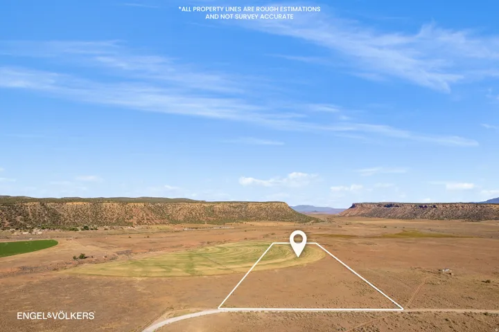 Expansive parcel featuring open terrain, distant mesa formations, and visible property boundary lines