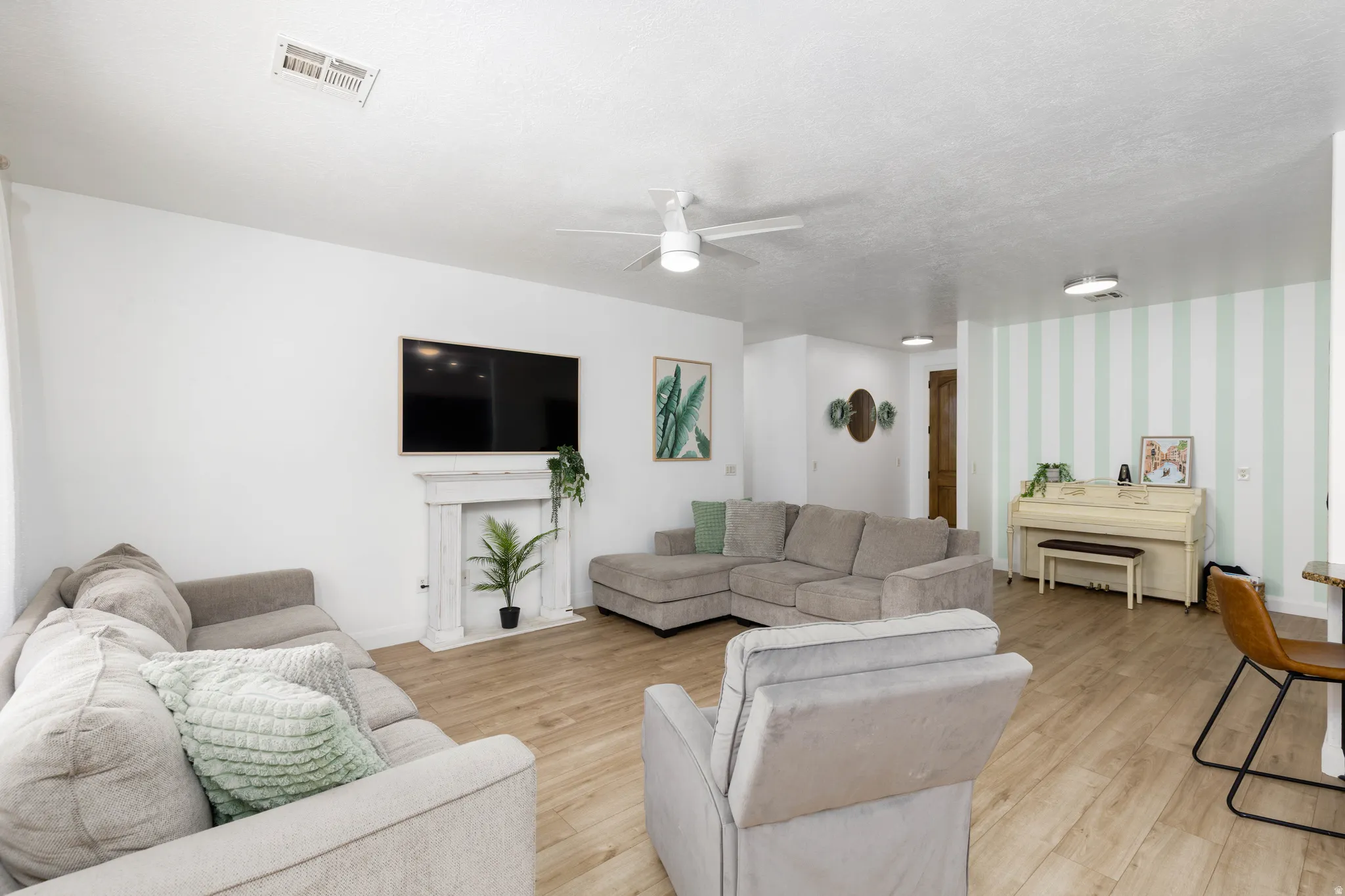 Open-concept living space with wood-finish flooring