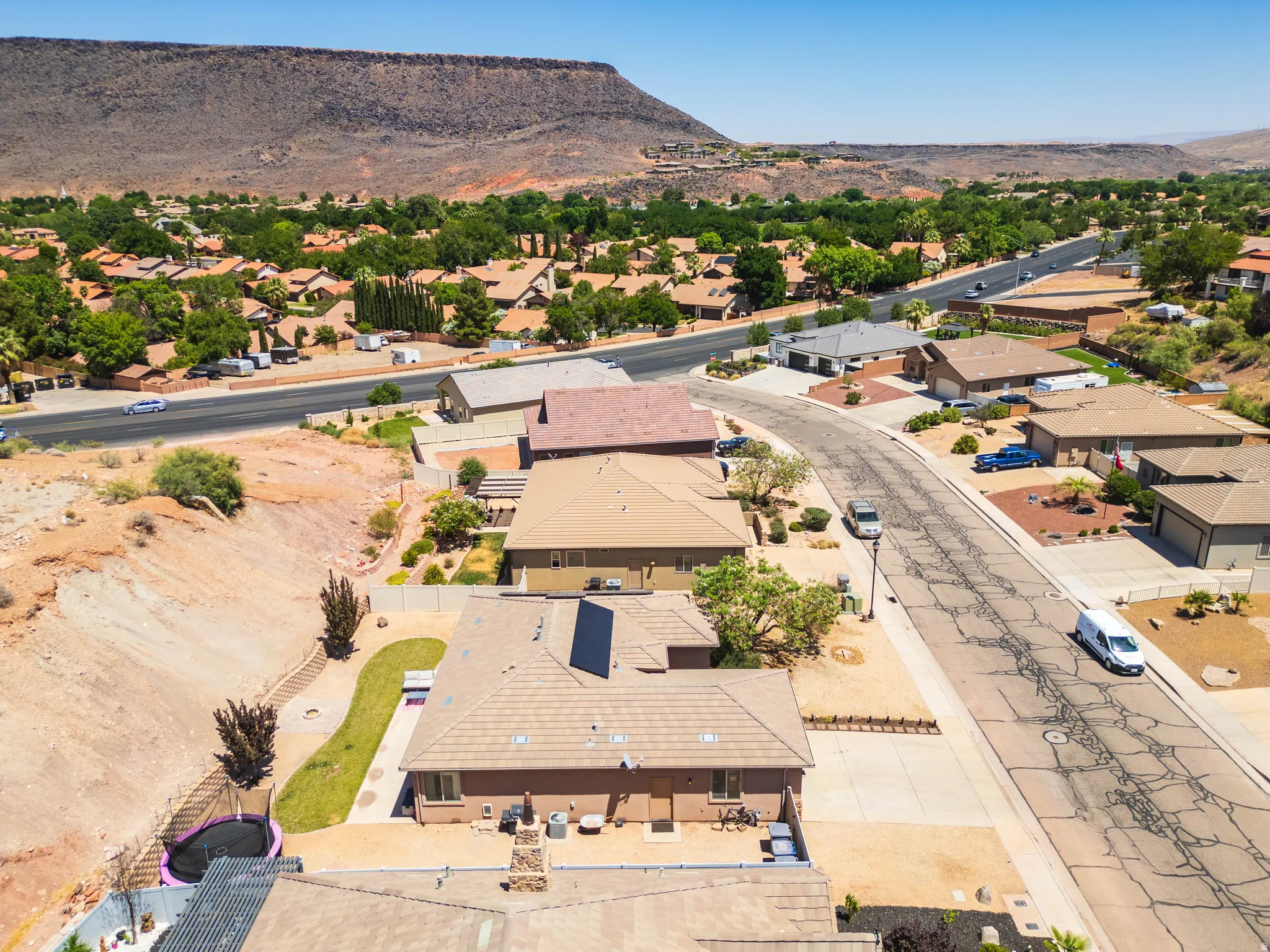 Aerial perspective showcasing residential properties with a mountainous backdrop