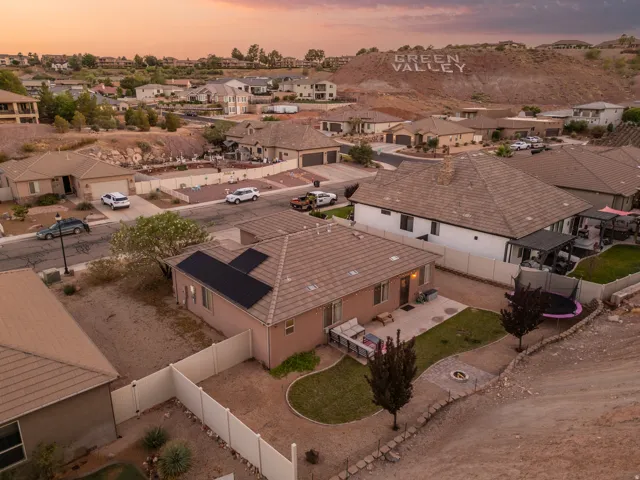 Residential property featuring a stucco exterior, tile roof, and solar panels