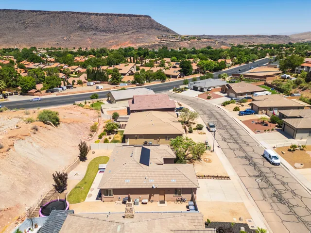 Aerial perspective showcasing residential properties with a mountainous backdrop