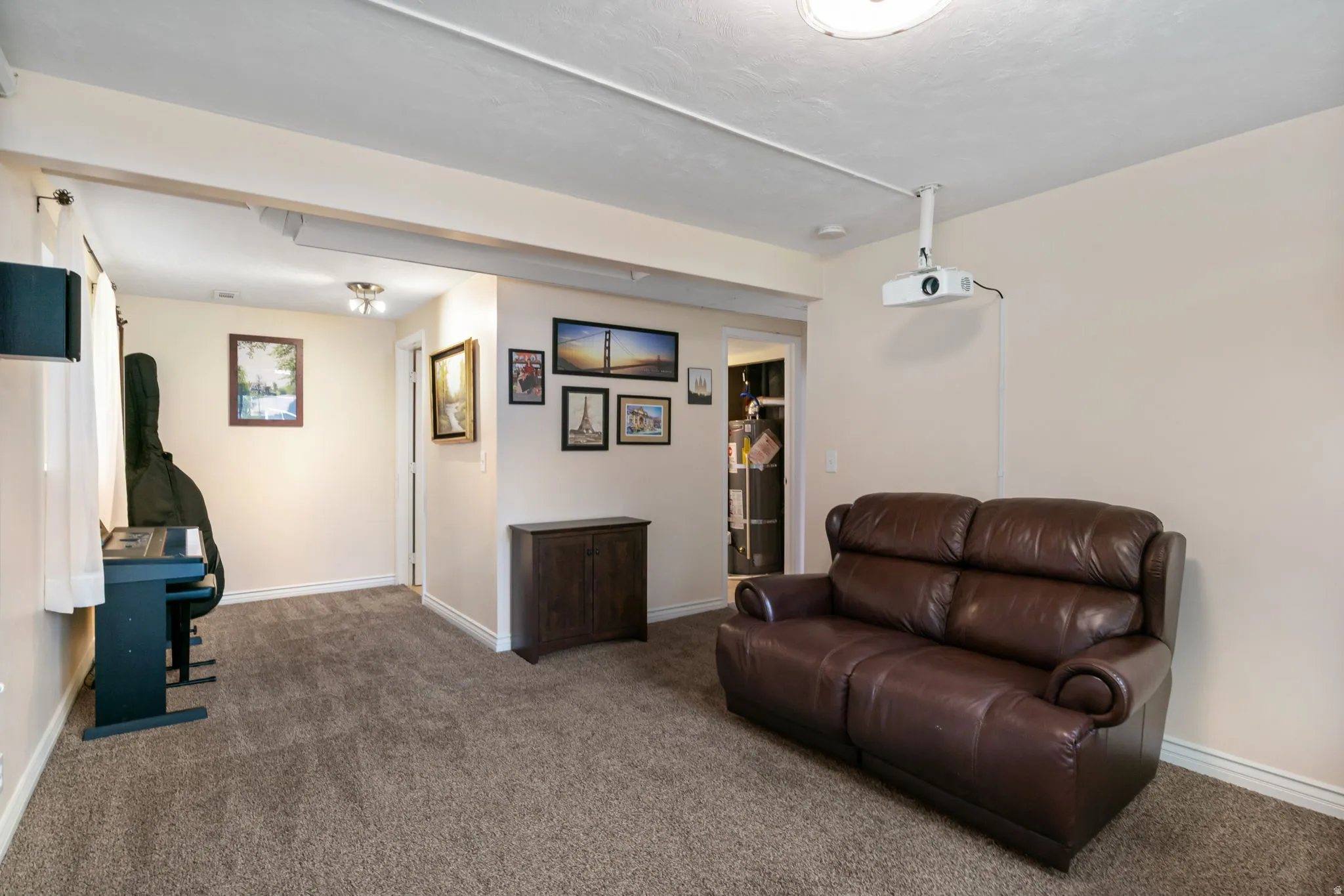 Spacious room with plush carpet flooring and a ceiling-mounted projector