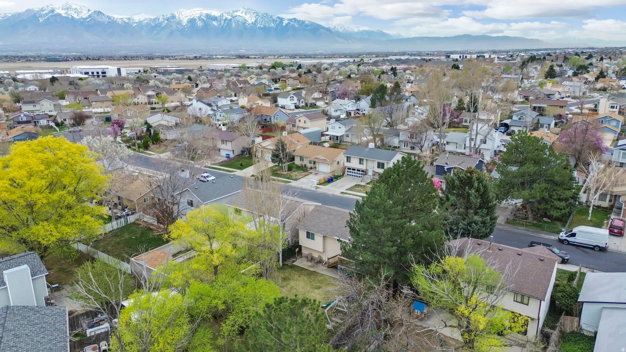 Residential neighborhood with a backdrop of snow-capped mountains