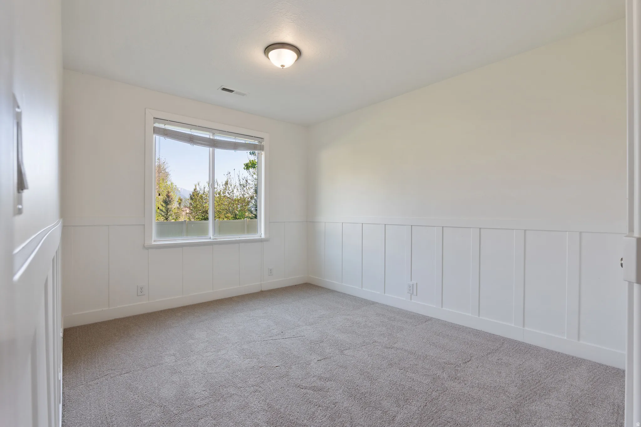 Neutral painted walls featuring board and batten wainscoting