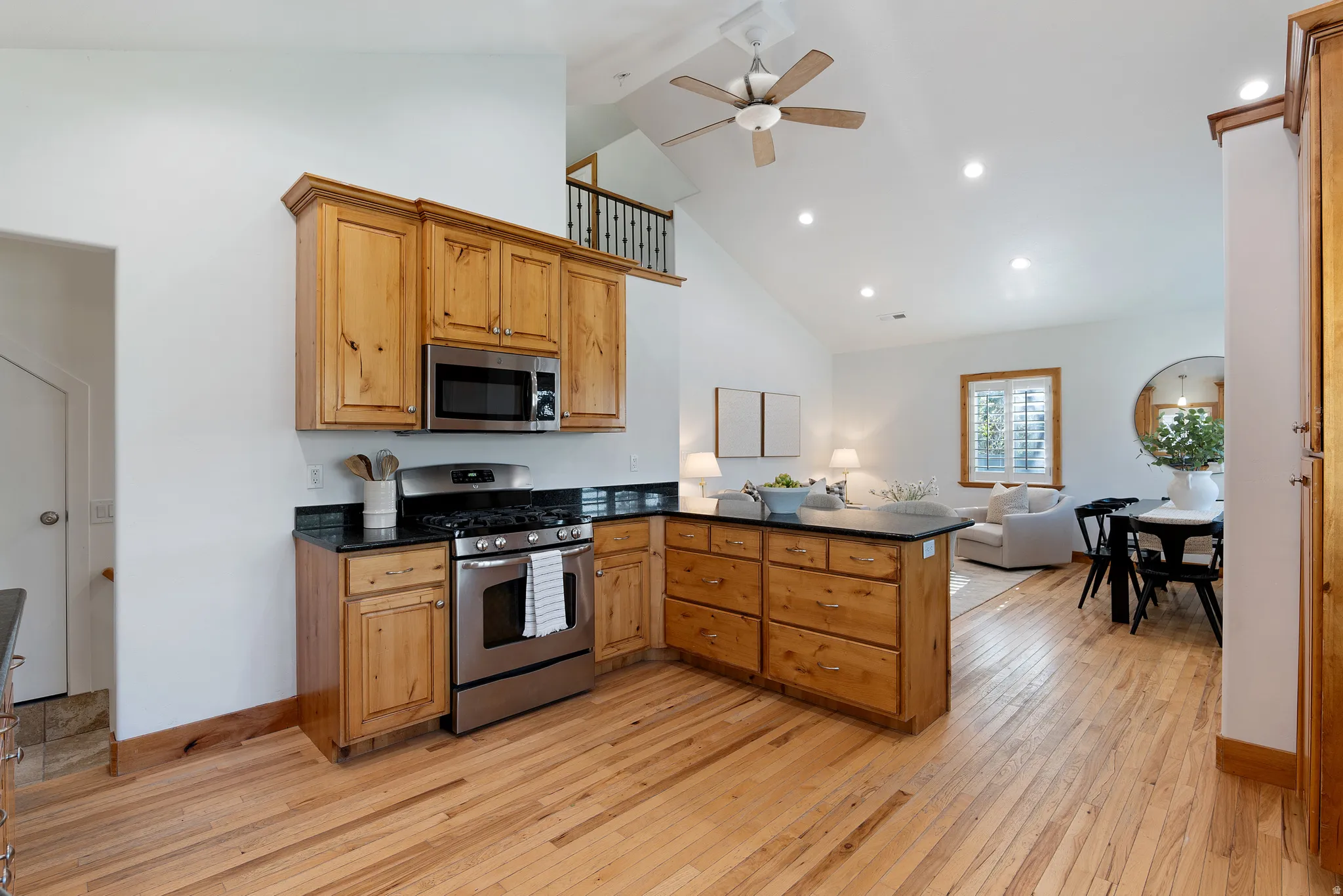 Kitchen featuring wood cabinetry, stainless steel appliances, and dark countertops