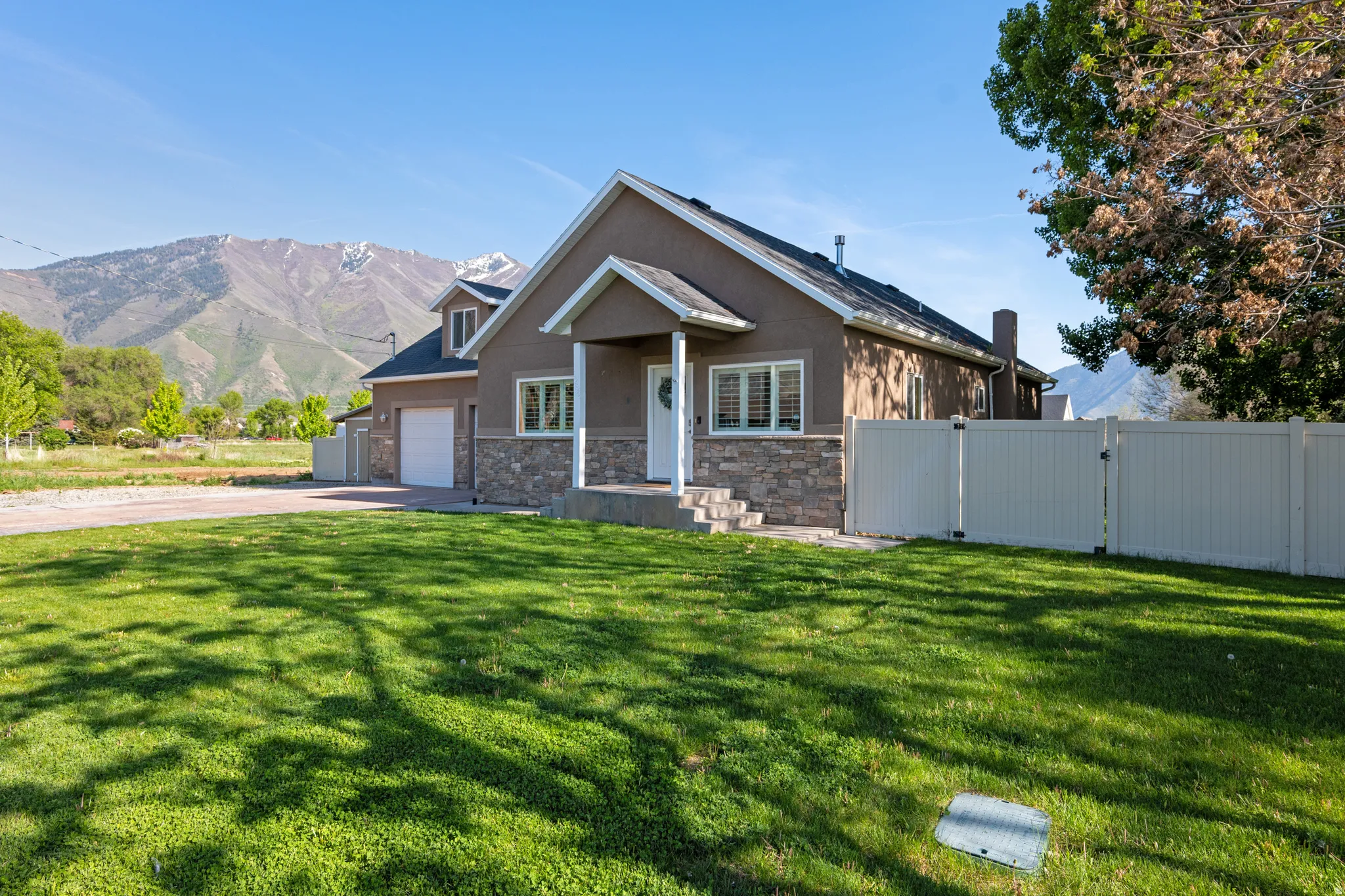 Taupe stucco exterior with stone accents and white trim