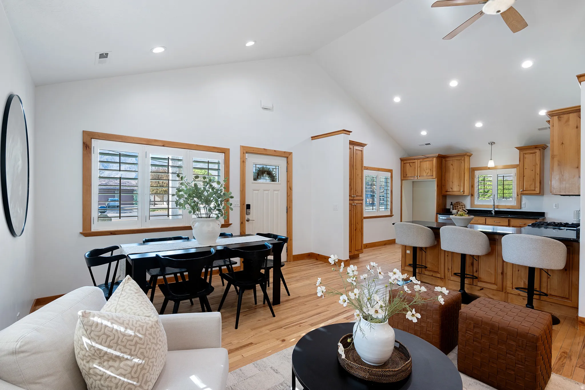 Vaulted ceilings complement the wood-finish flooring throughout the open-concept living area