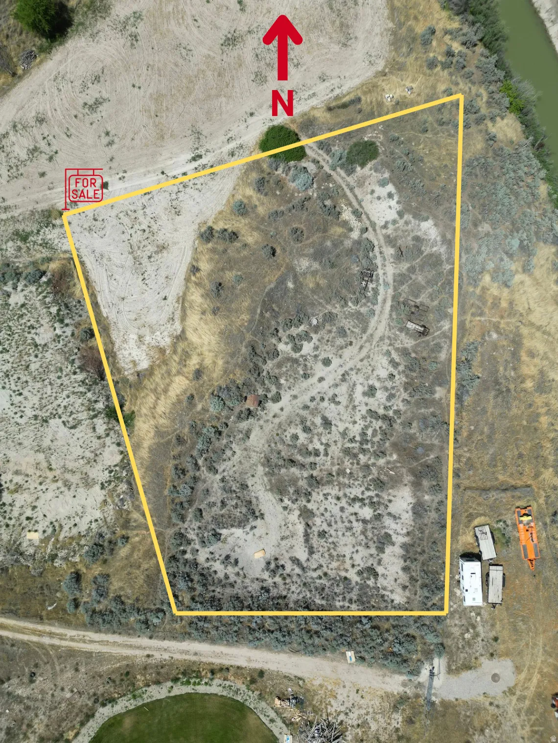 Aerial View. Illustrating the boundaries of the property with a directional indicator. For Sale sign located on North West Corner of Lot.