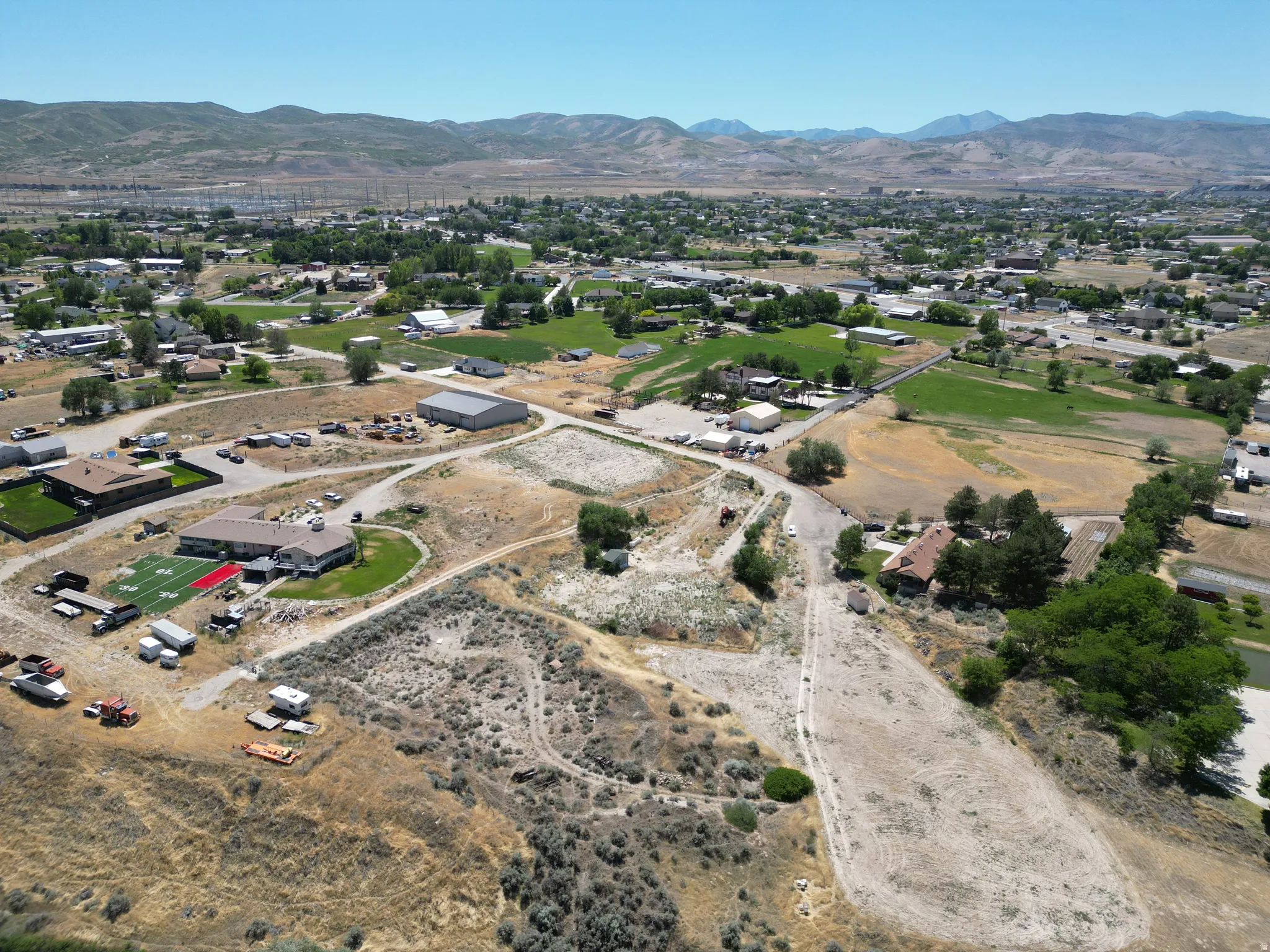 Aerial perspective showcasing extensive acreage with multiple structures