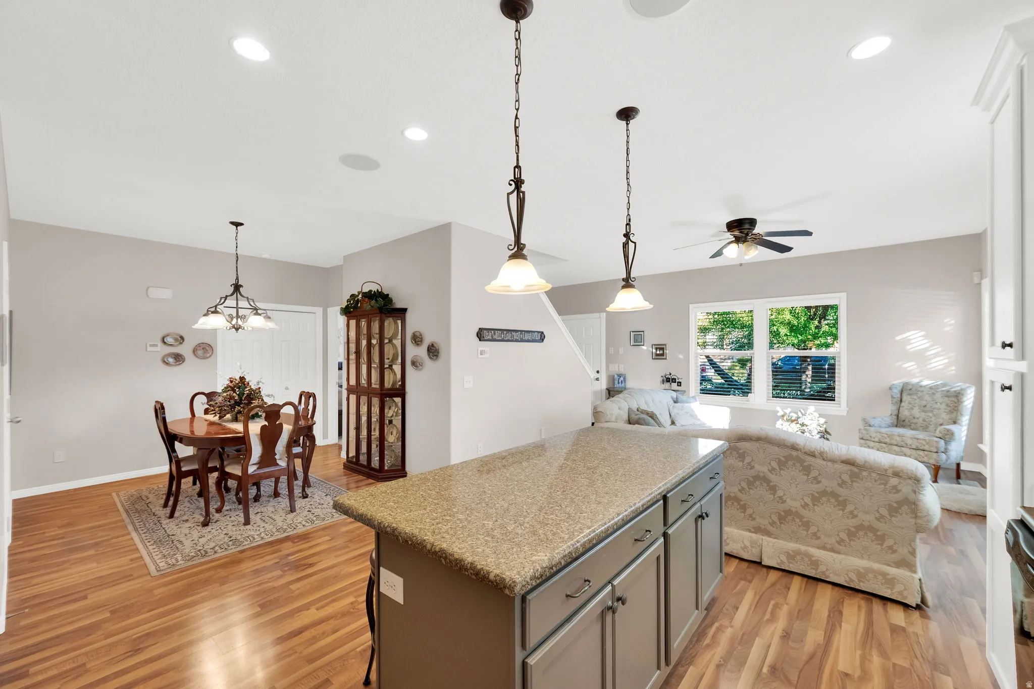 Kitchen island with a granite-style countertop and painted cabinetry