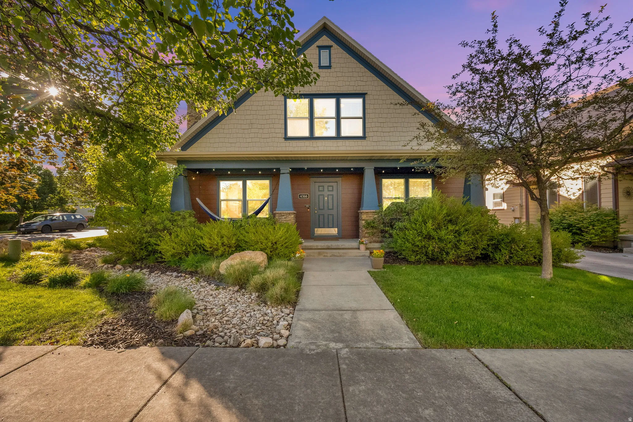 Craftsman-style facade with a prominent front porch and shaker siding