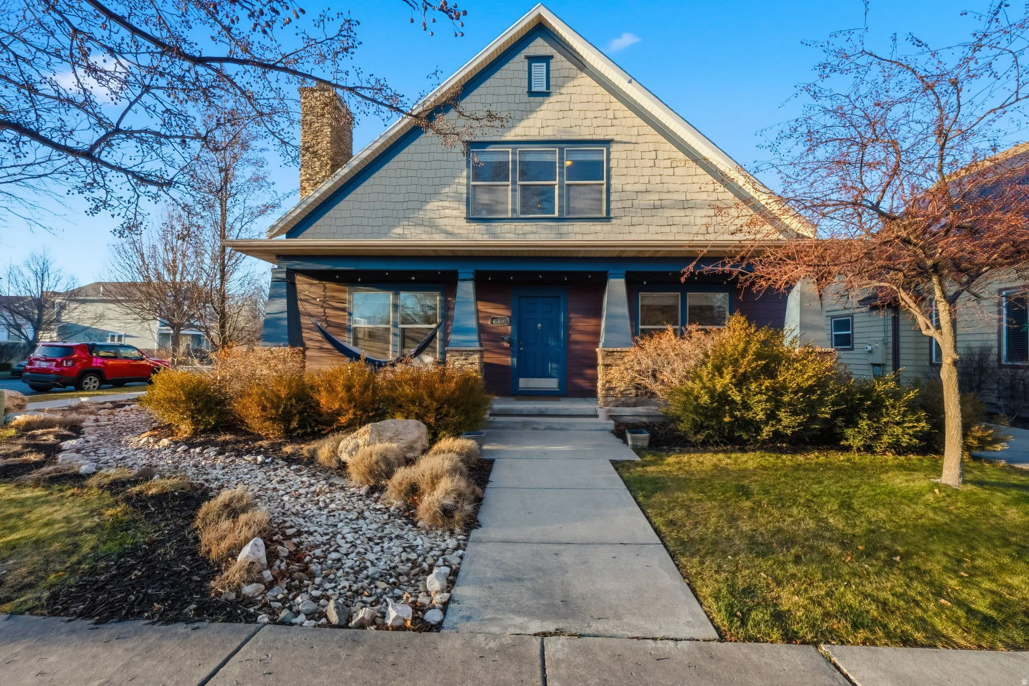 Craftsman-style facade with blue siding and natural wood accents
