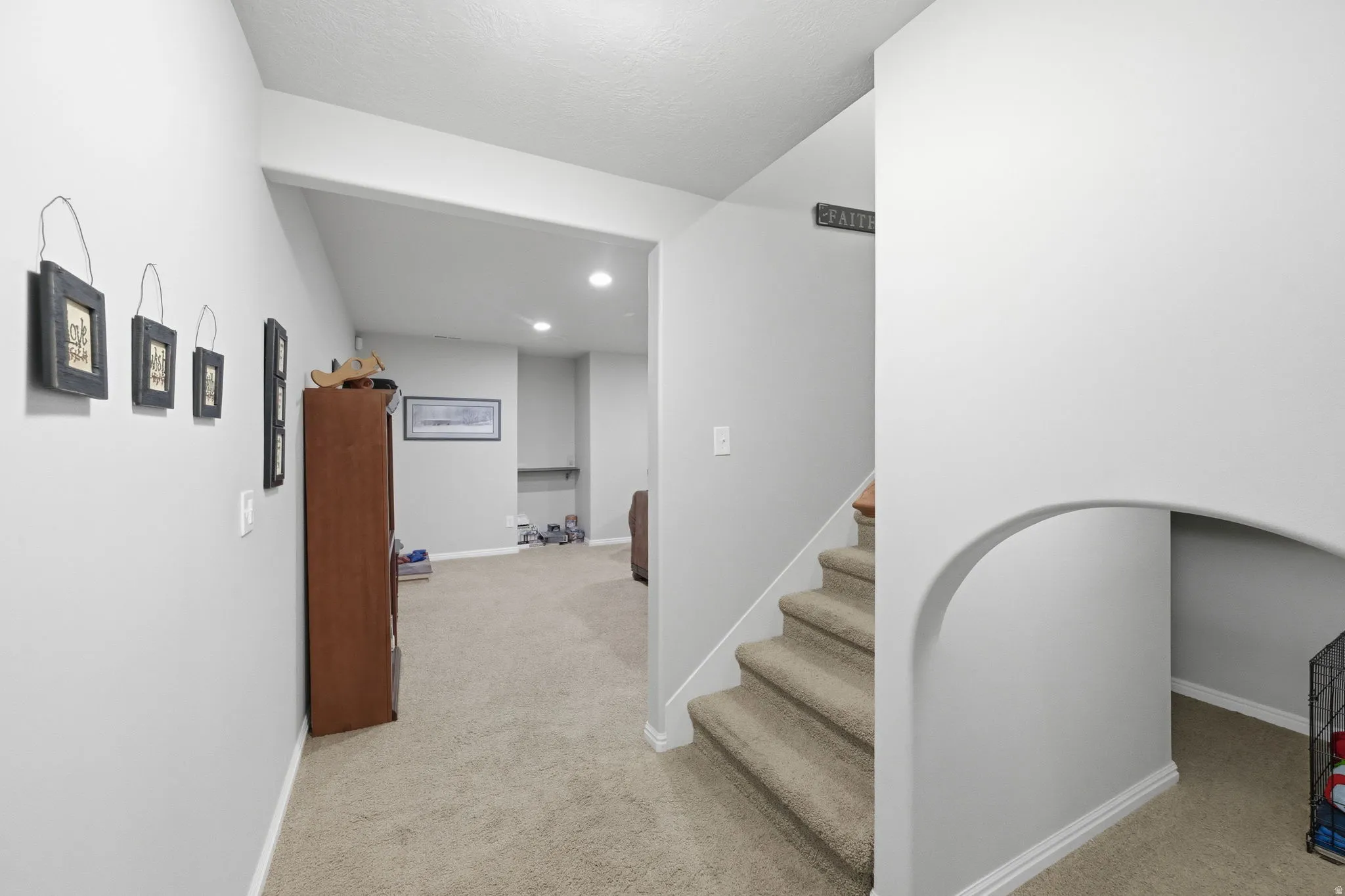 Carpeted staircase with white risers and a white banister