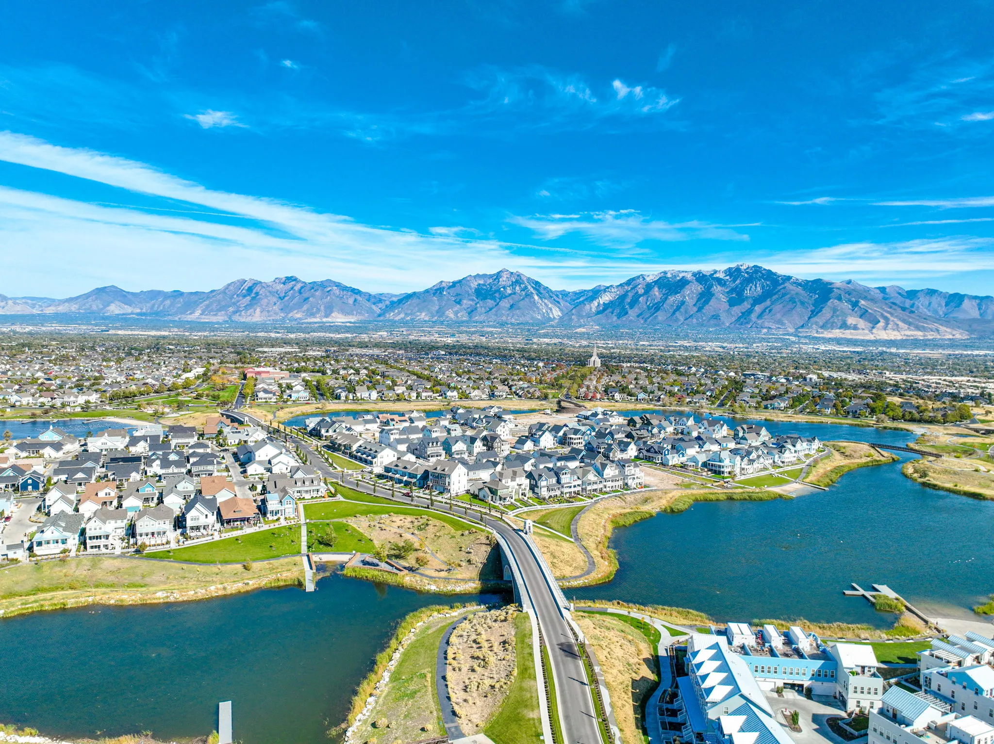 Aerial perspective showcasing a residential community with abundant green spaces and extensive bodies of water
