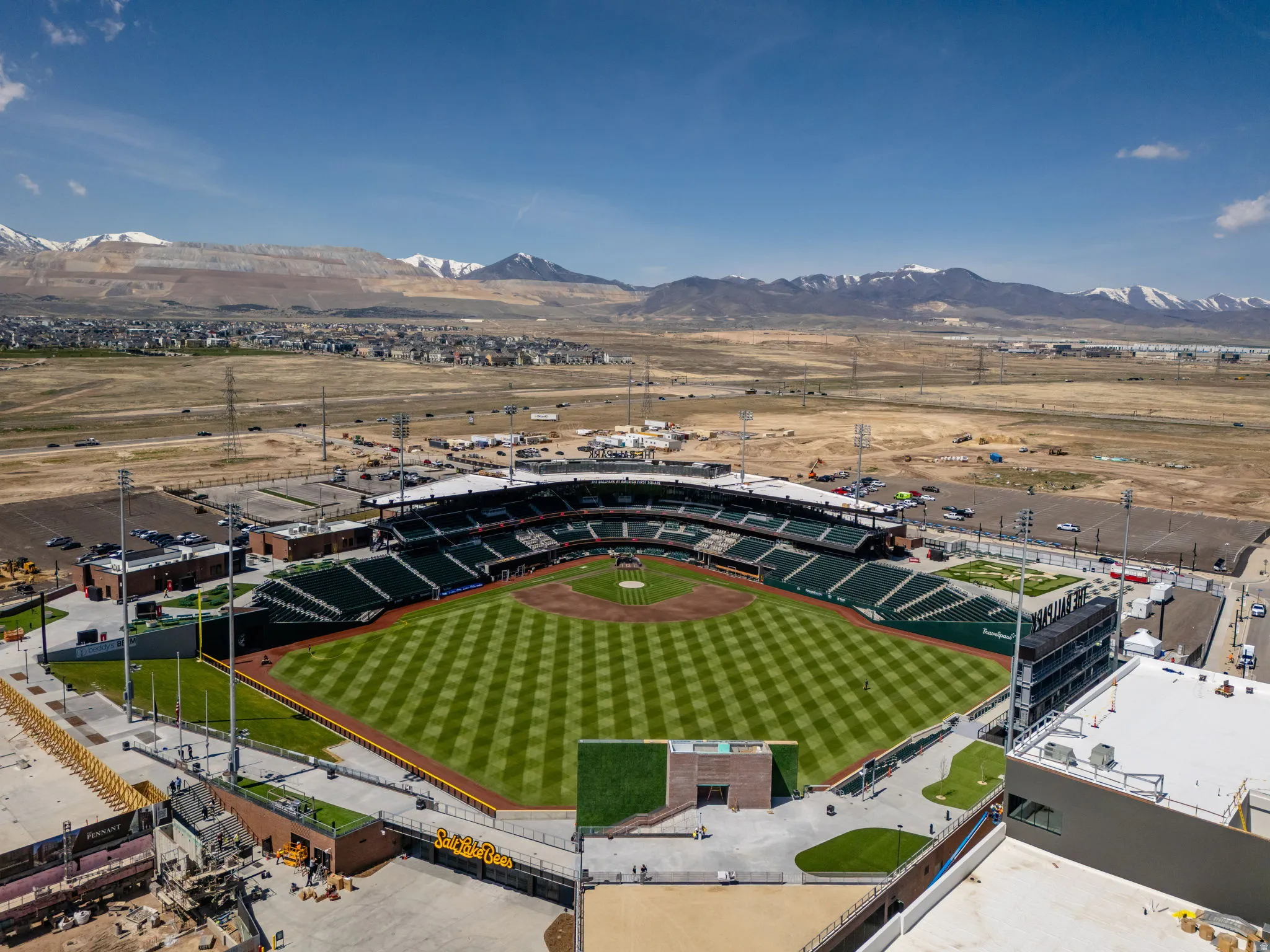 Baseball stadium featuring a manicured field, spectator seating, and surrounding paved areas