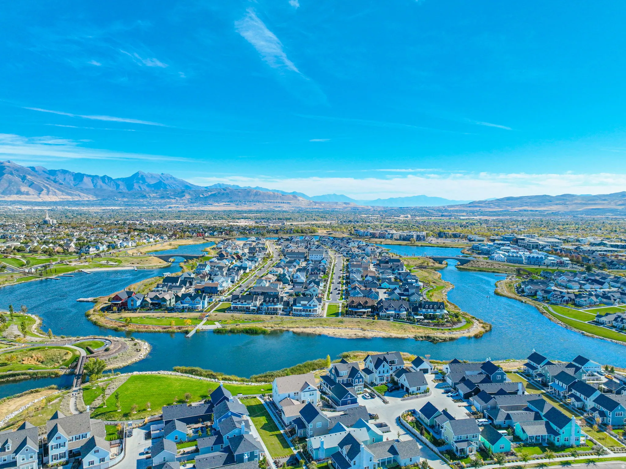 Expansive aerial perspective showcasing a residential development with a prominent waterway