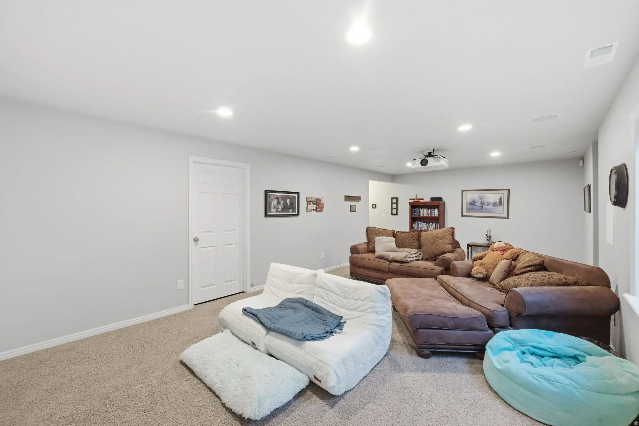 Spacious room featuring light gray walls and recessed lighting