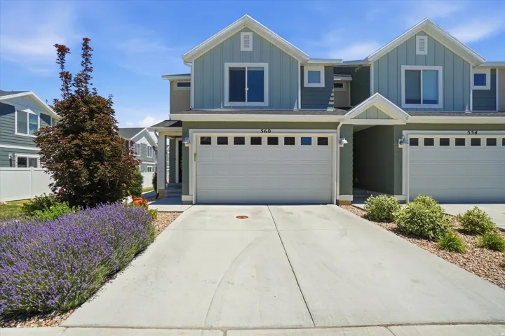 Contemporary exterior featuring board and batten siding, a single-car garage, and a concrete driveway