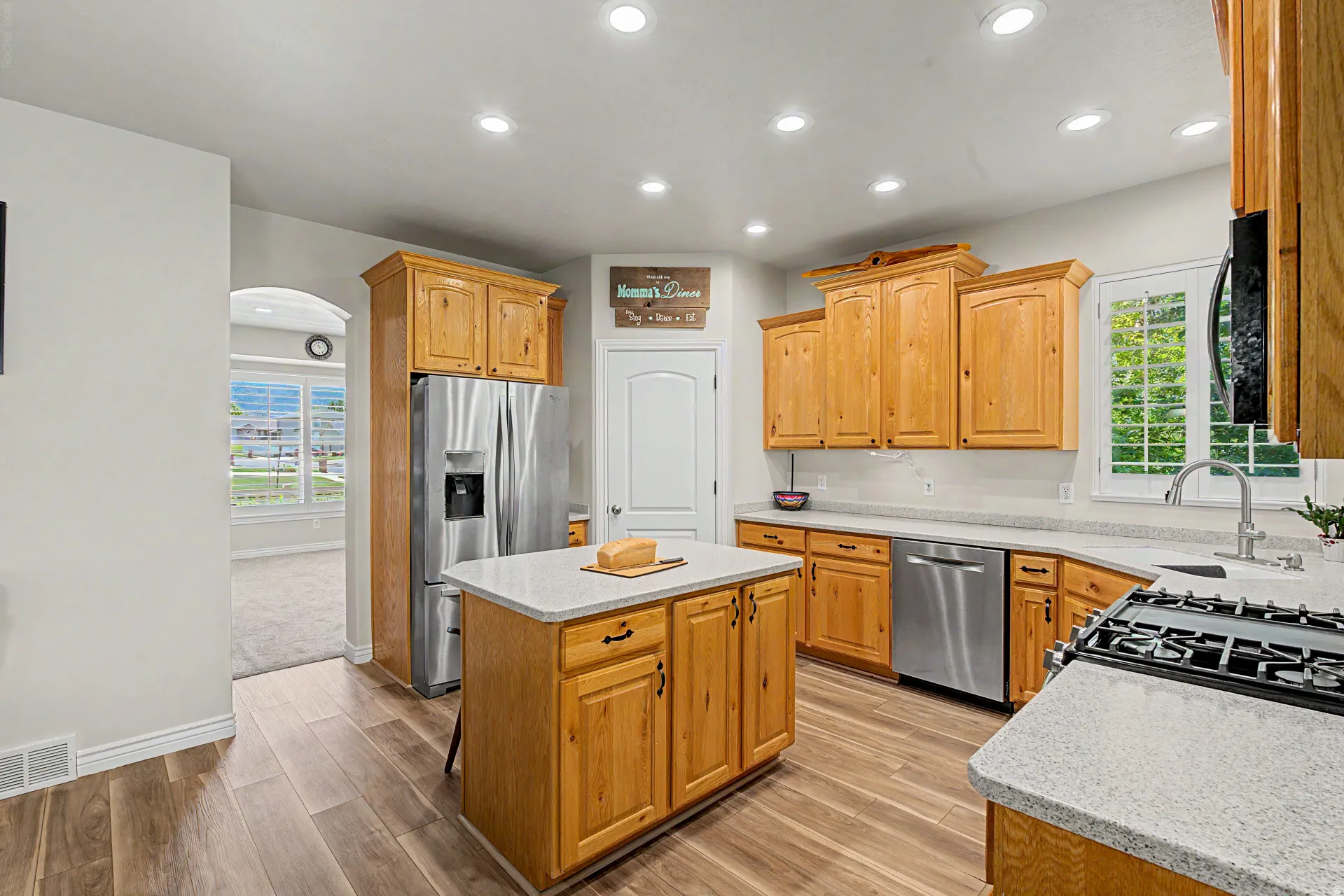 Kitchen featuring wood-finish flooring, recessed lighting, and light wood cabinetry