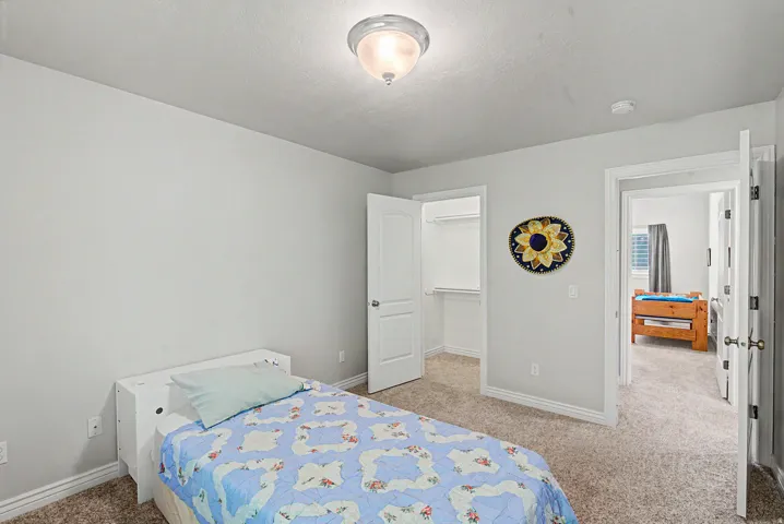 Carpeted room with light gray walls, white trim, and a semi-flush mount ceiling light