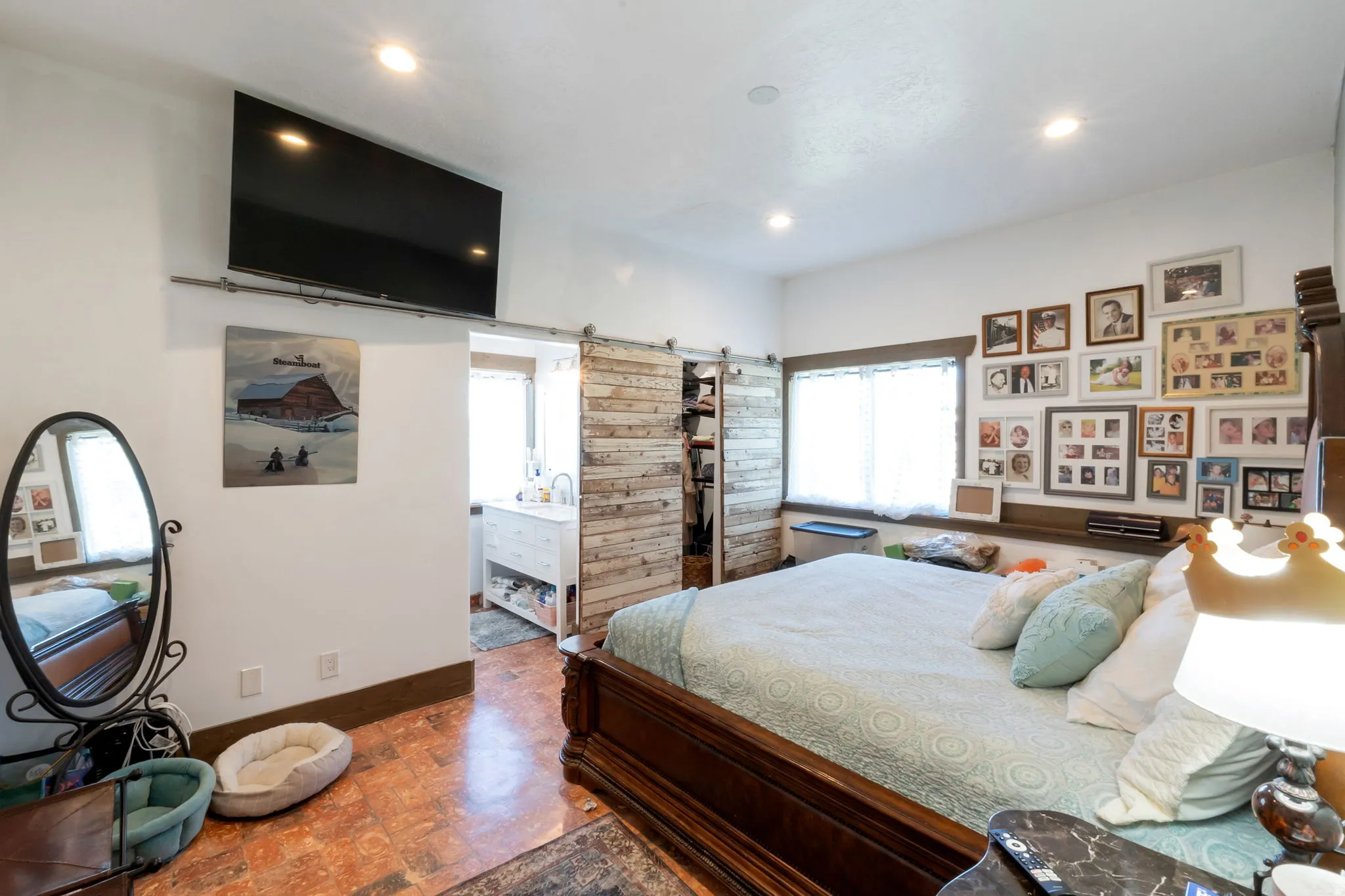 Bedroom with recessed lighting, wood-finish flooring, and a window with white blinds with 3/4 bathroom