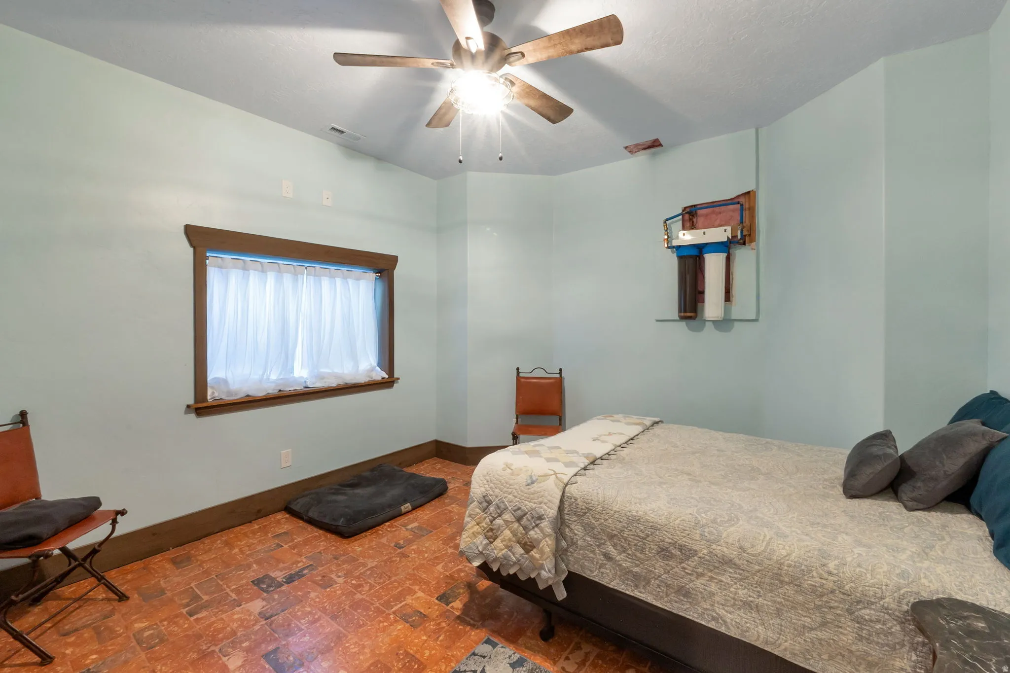 Interior room with light blue walls and a multi-toned wood-finish ceiling fan