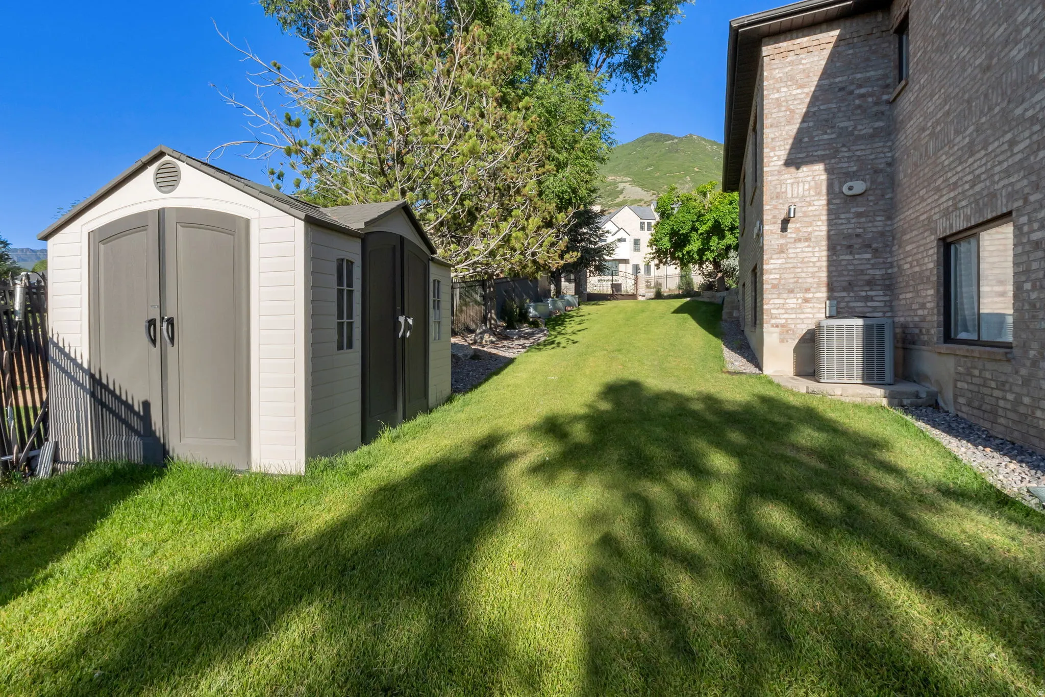 Expansive side yard featuring a storage shed.