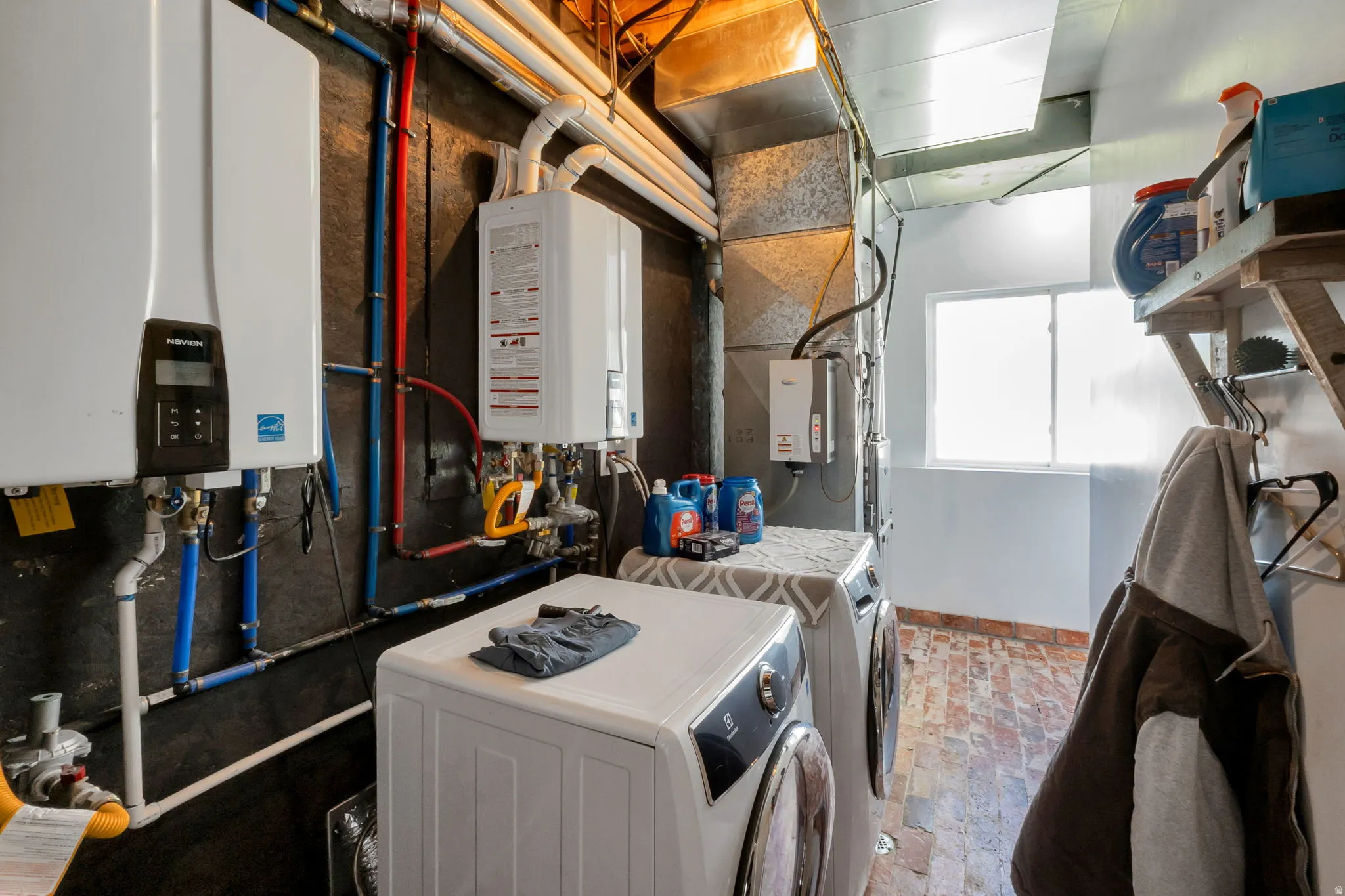 Utility room featuring two tankless water heaters, updated furnaces recemntly serviced.