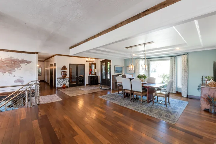 Spacious interior featuring wood-finish flooring, exposed ceiling beams, and a coffered ceiling detail
