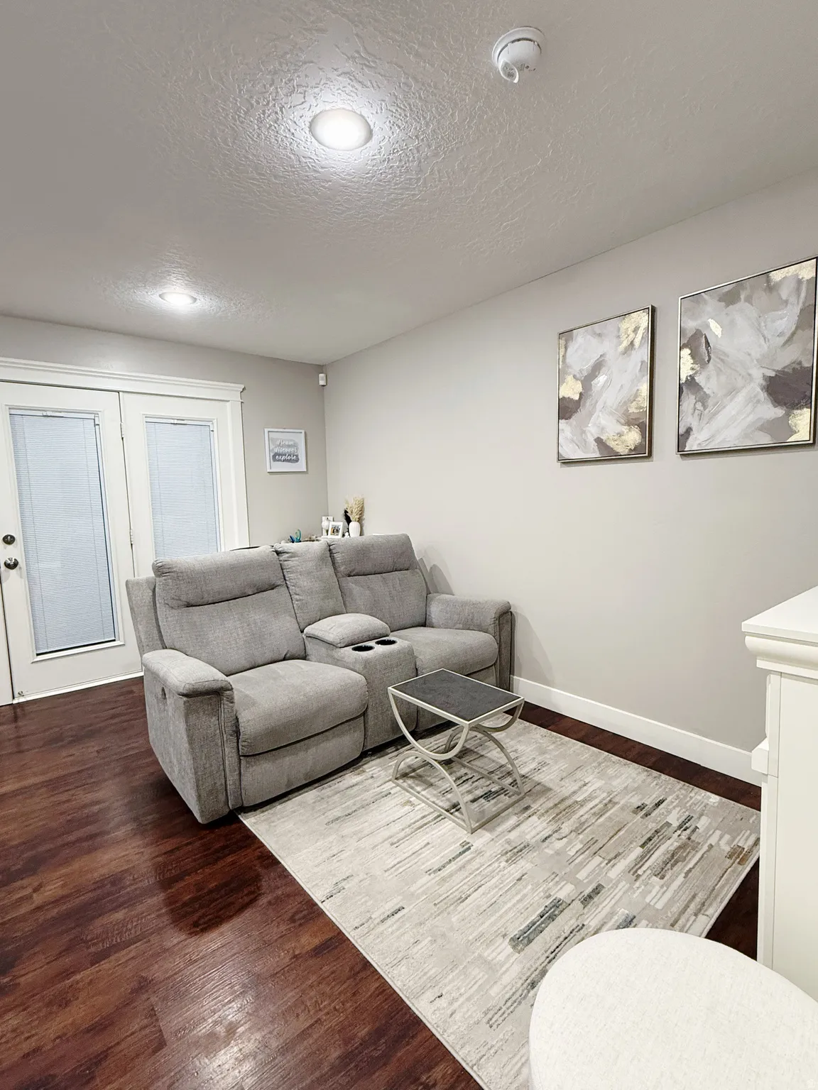 Warm wood-finish flooring complements the neutral wall tones