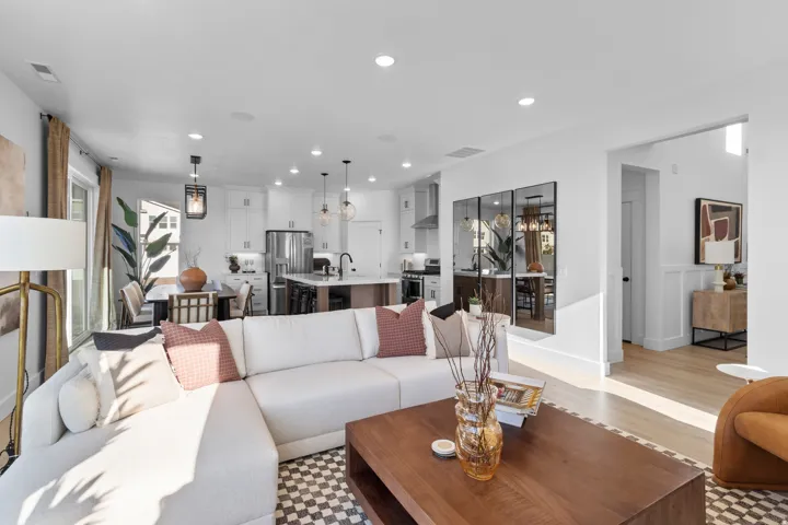 Bright open-concept living area with light wood-finish flooring