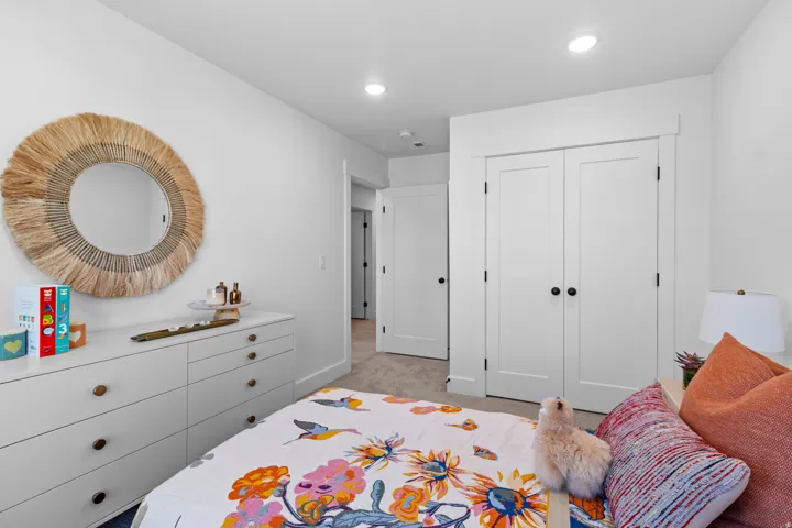 Bedroom featuring white walls, recessed lighting, and neutral carpeting