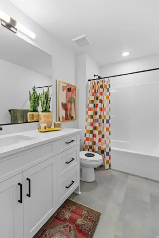 White vanity with single integrated sink and black hardware