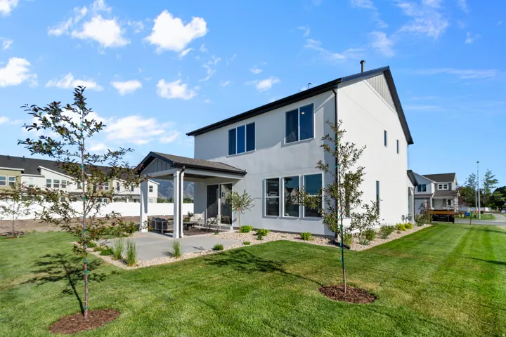 Contemporary two-story residence with a covered patio and a concrete slab