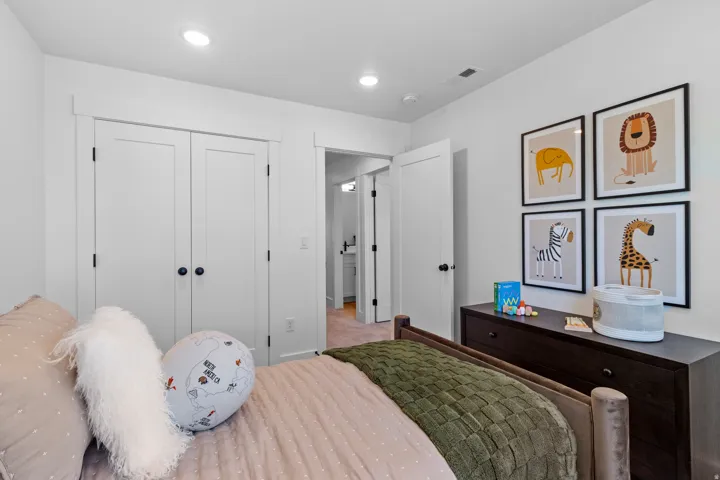 Interior room with white walls, recessed lighting, and a neutral-toned carpet