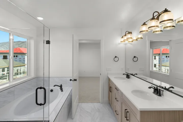 Contemporary bathroom featuring a spacious built-in tub with marble-look tile surround and a clear glass shower enclosure