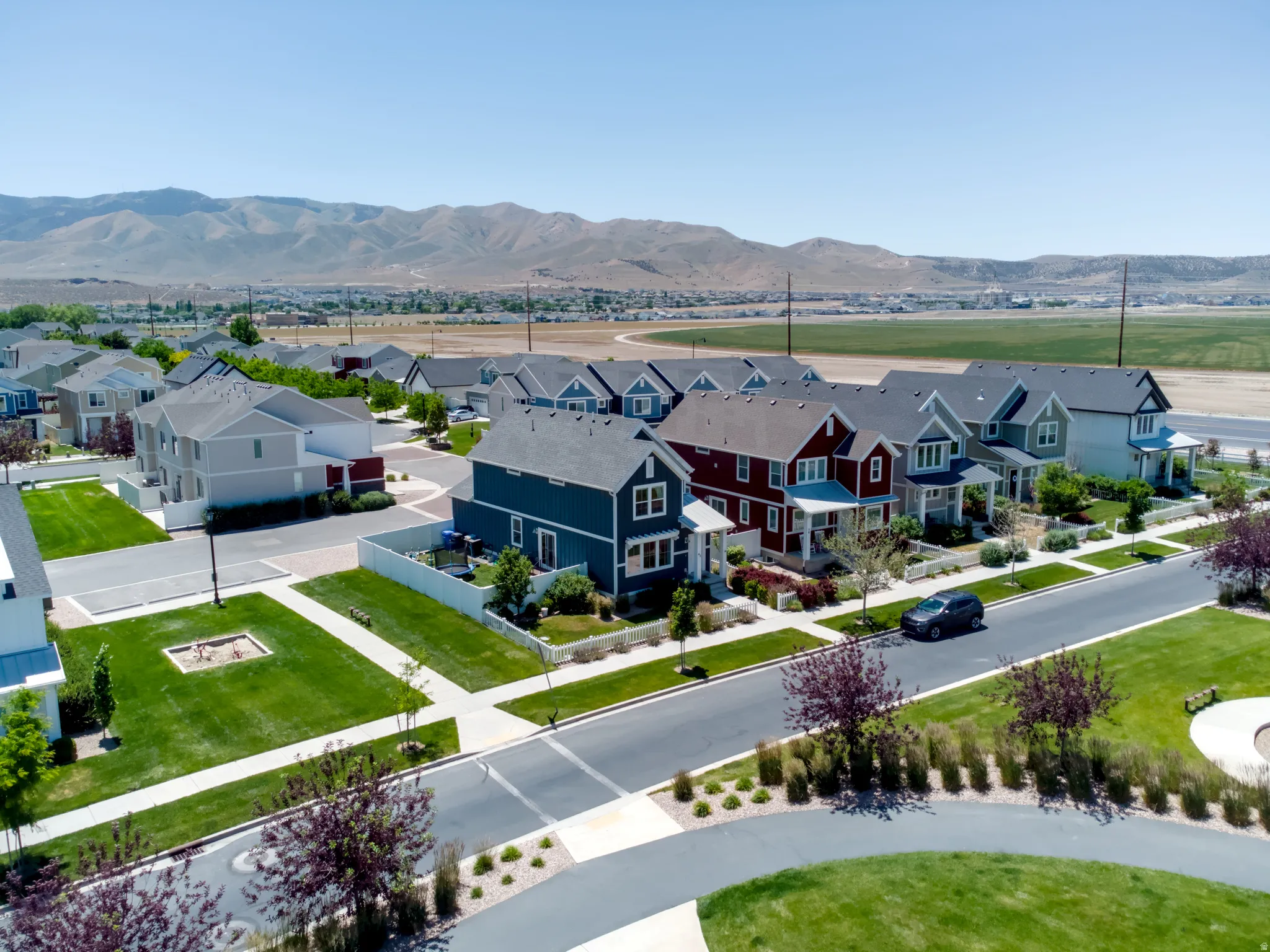 Residential community featuring a variety of home styles, paved streets, and landscaped public areas