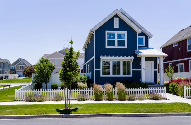 Modern two-story residence featuring deep blue siding and white trim