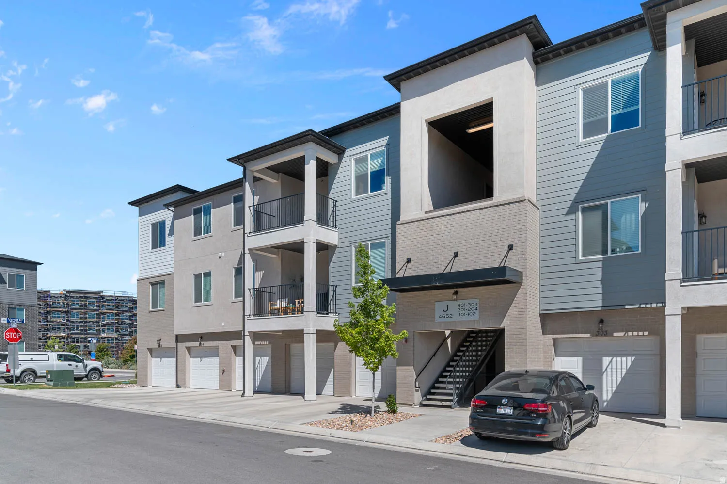 Modern multi-story building featuring a blend of horizontal siding and stucco finishes
