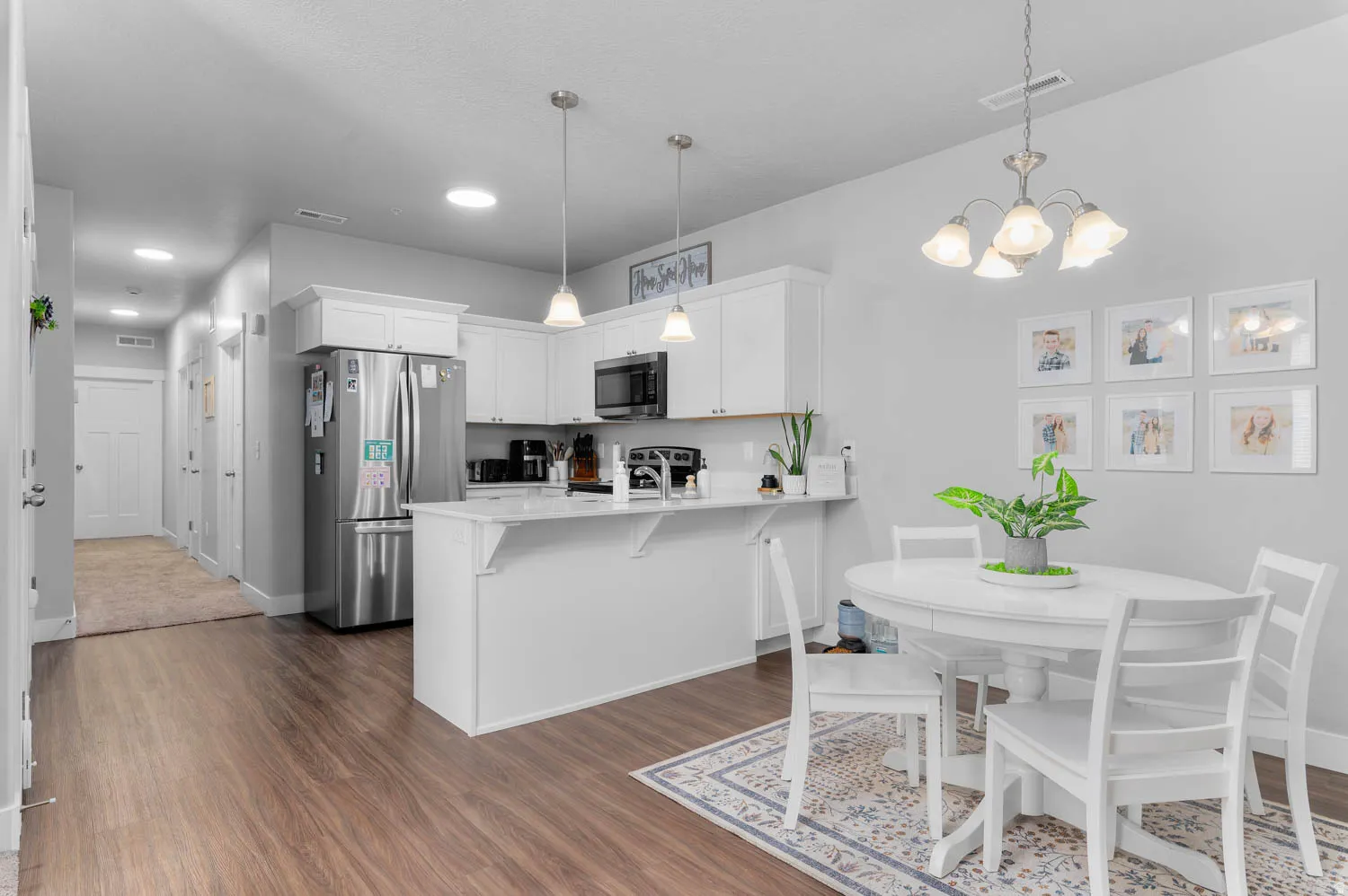 Kitchen featuring white cabinetry, stainless steel appliances, and a breakfast bar