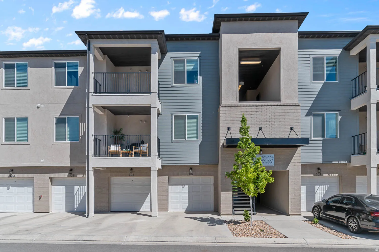 Contemporary multi-story facade featuring varied siding and stucco finishes