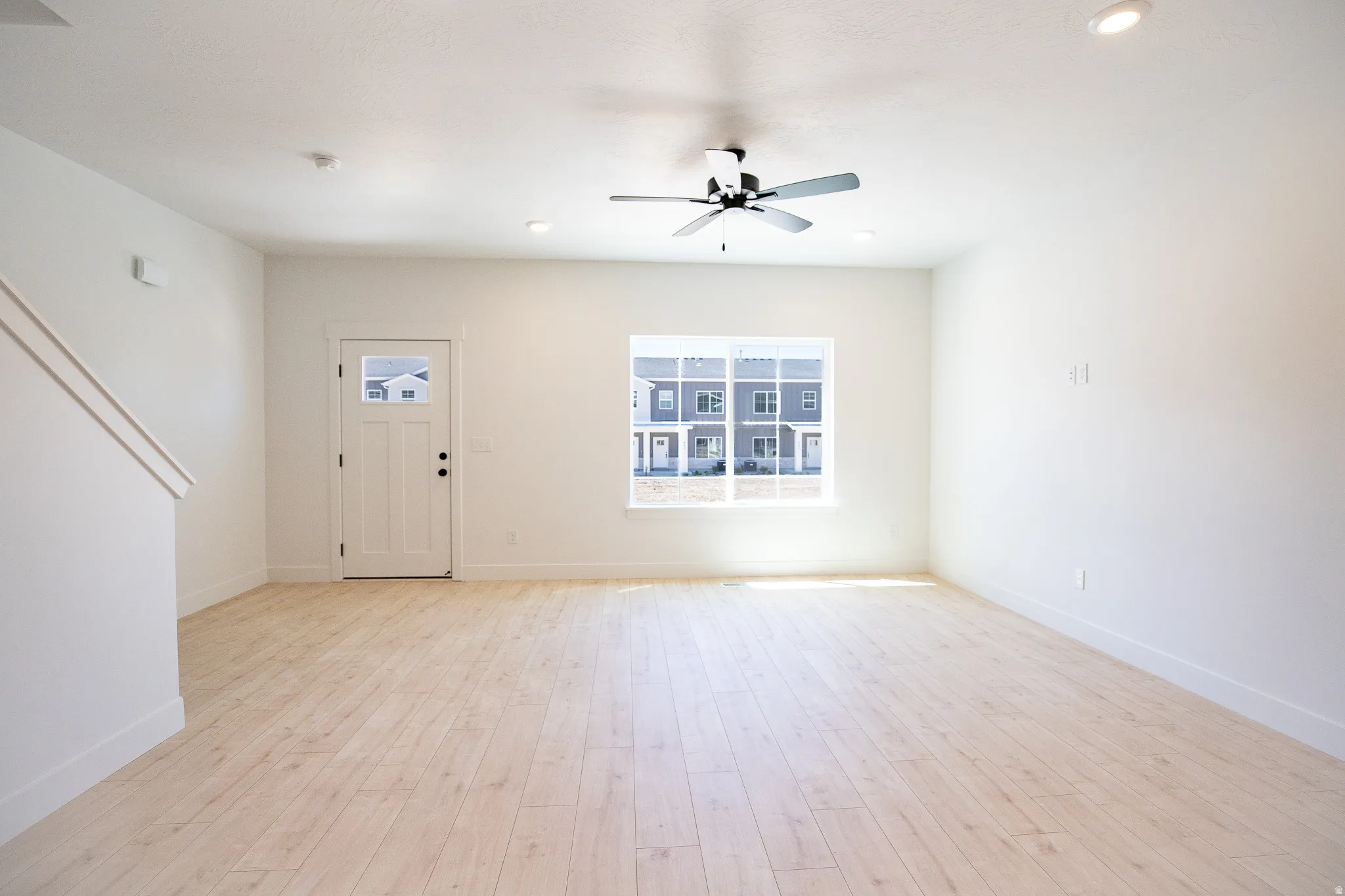 Spacious family room with view of park out the front window