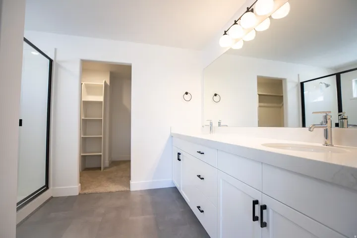 Primary bathroom with a double vanity and large walk-in shower