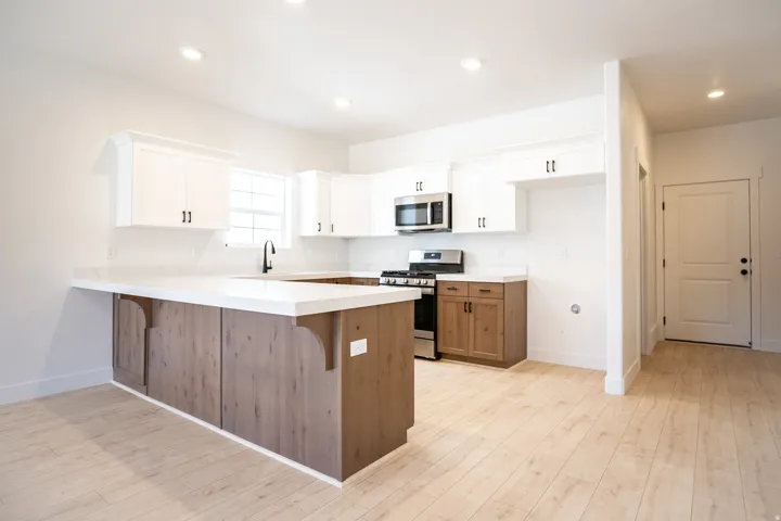 Large kitchen with upgraded cabinets, quartz counters, and stainless steel appliances