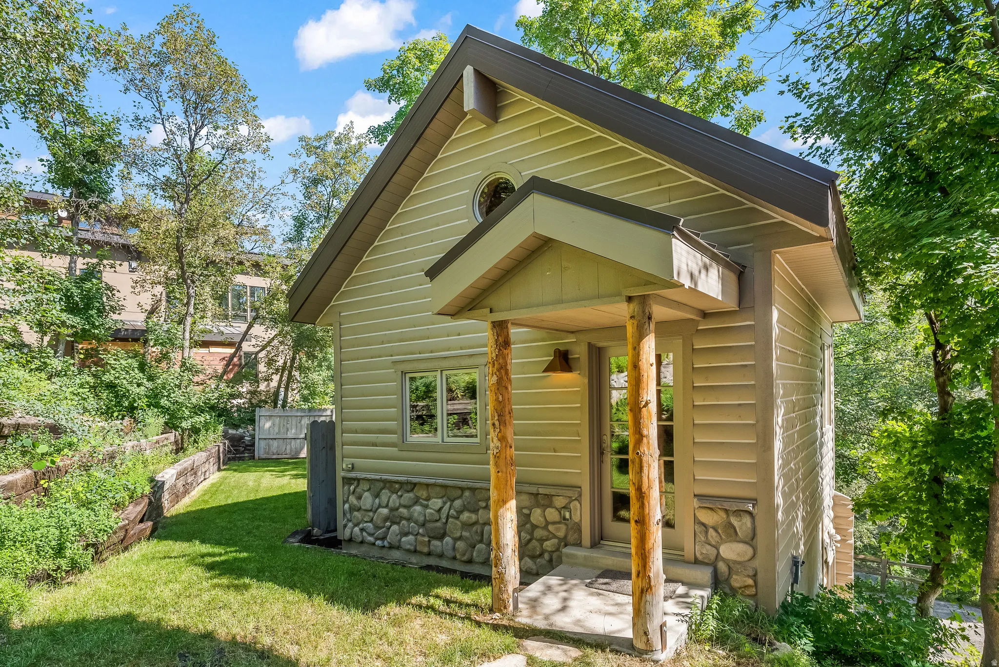 Charming exterior featuring horizontal siding and a natural stone foundation