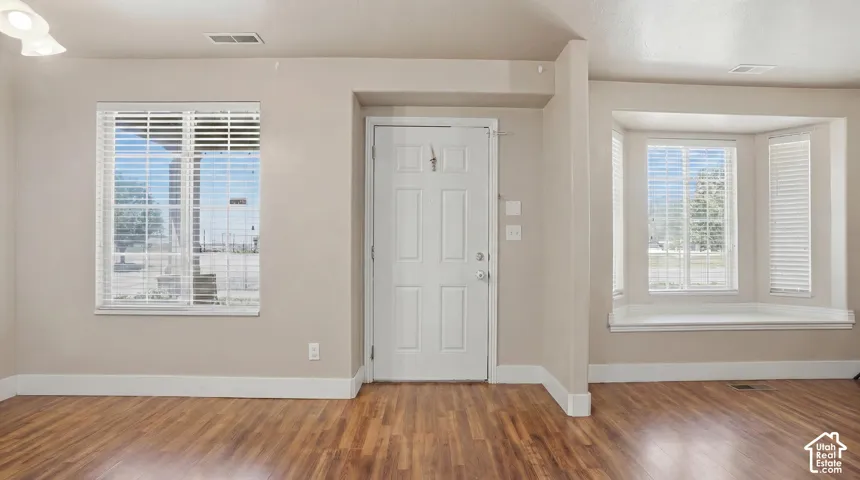 Warm wood-finish flooring complements neutral wall tones