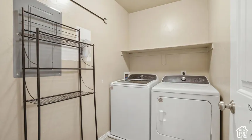 Dedicated laundry area featuring a built-in wall shelf and convenient appliance hookups