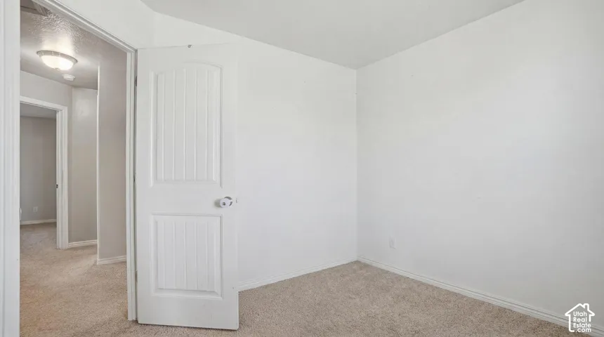 Neutral-toned carpeting paired with light-colored walls and white trim