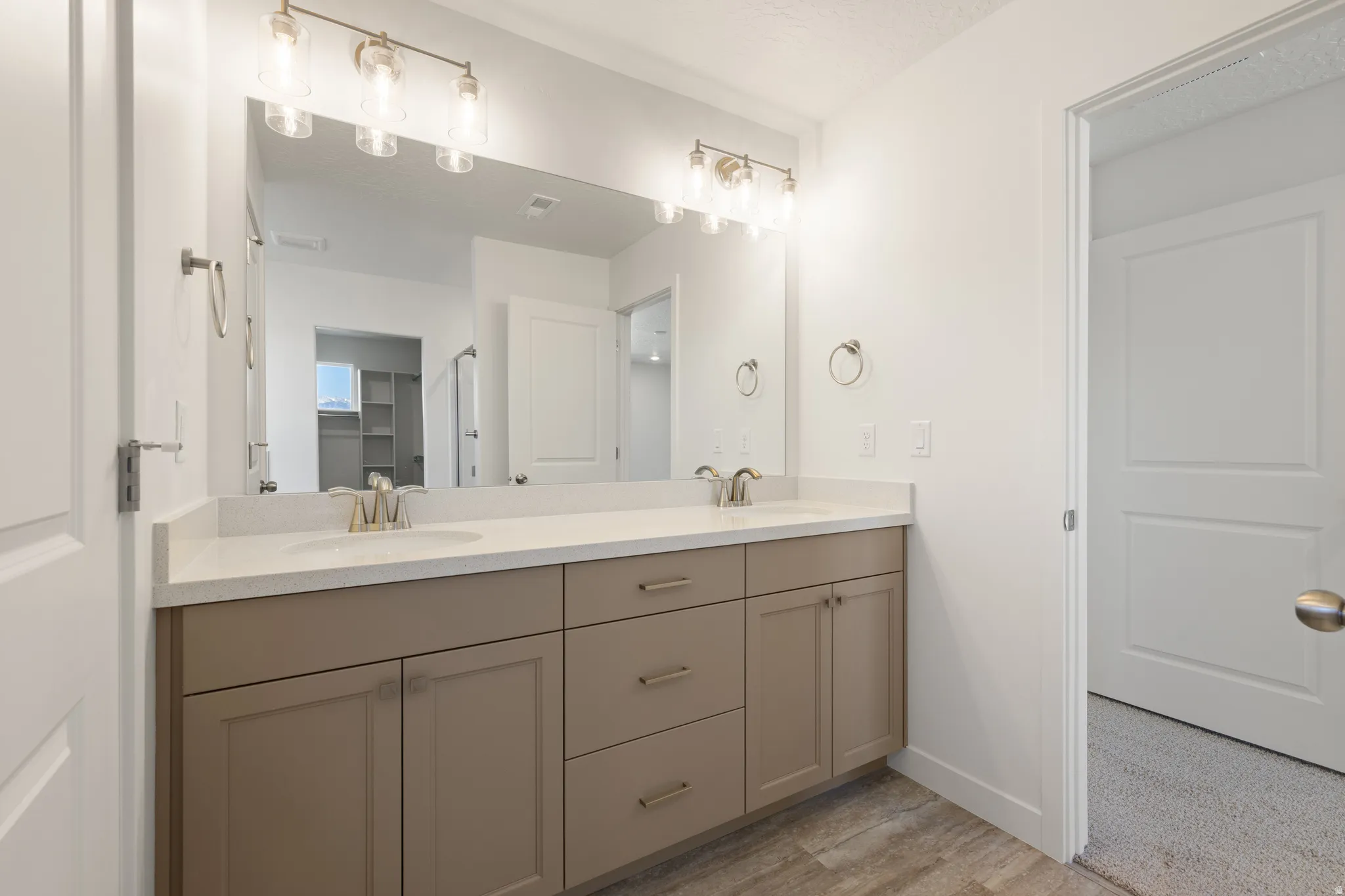 Dual vanity with undermount sinks and brushed nickel faucets